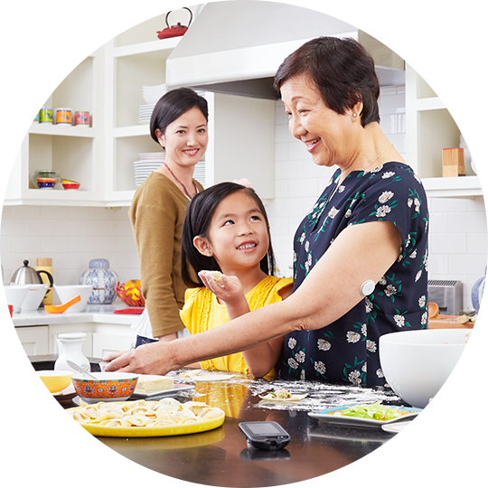 A man wearing a FreeStyle Libre sensor while cooking for his family.
