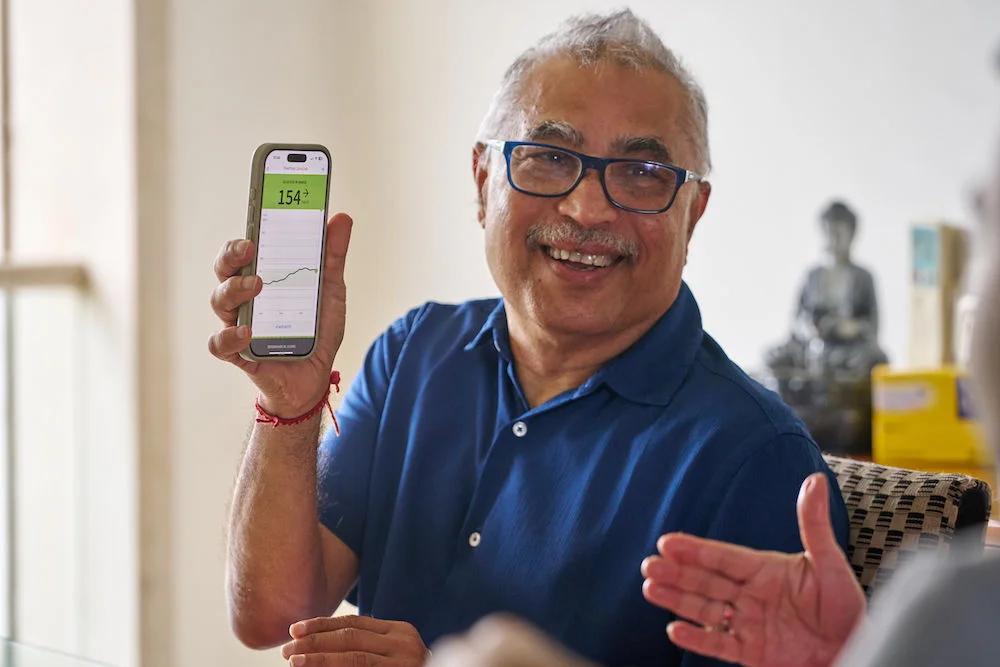A man holding up FSL app on his phone