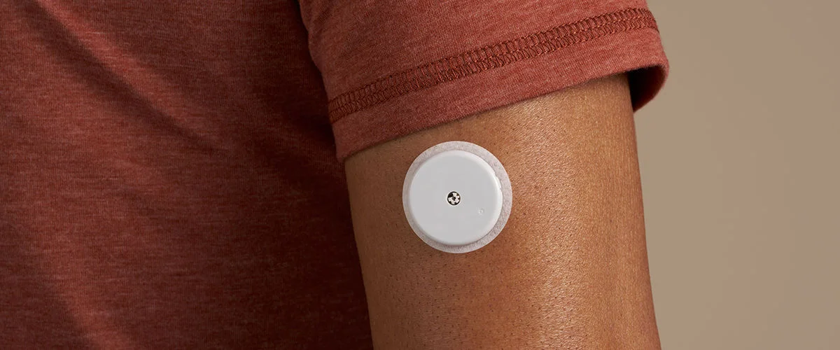 A close up of a FreeStyle Libre sensor on the back of person's arm