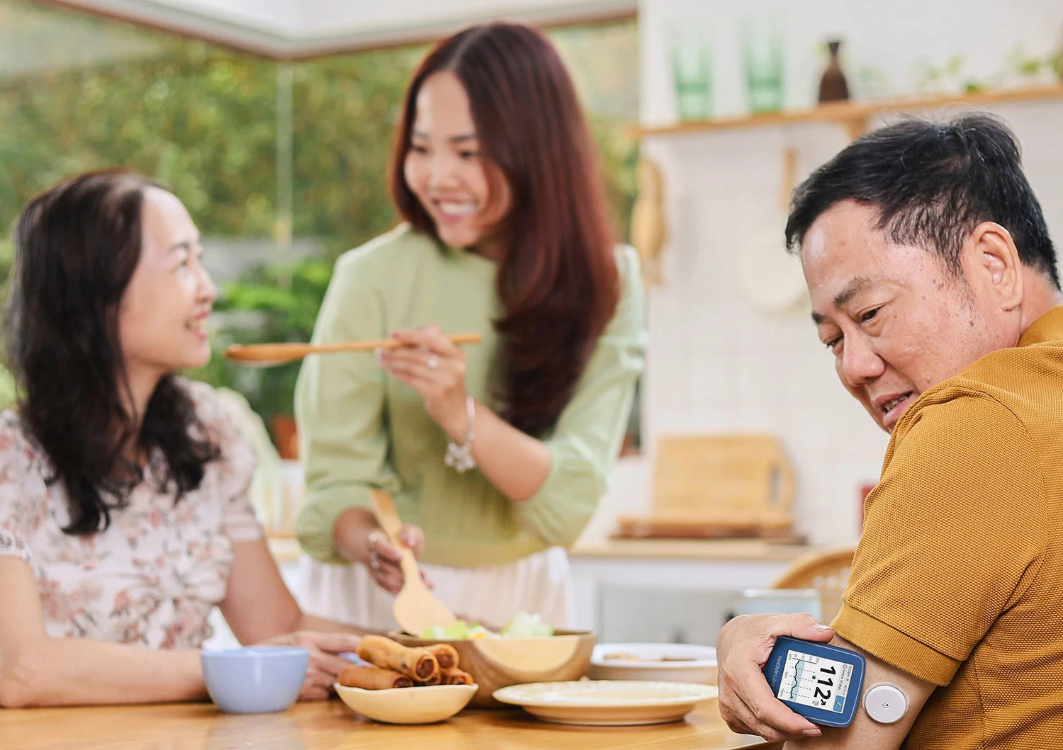 Man looking at his FreeStyle Libre 2 reader while working in a workshop