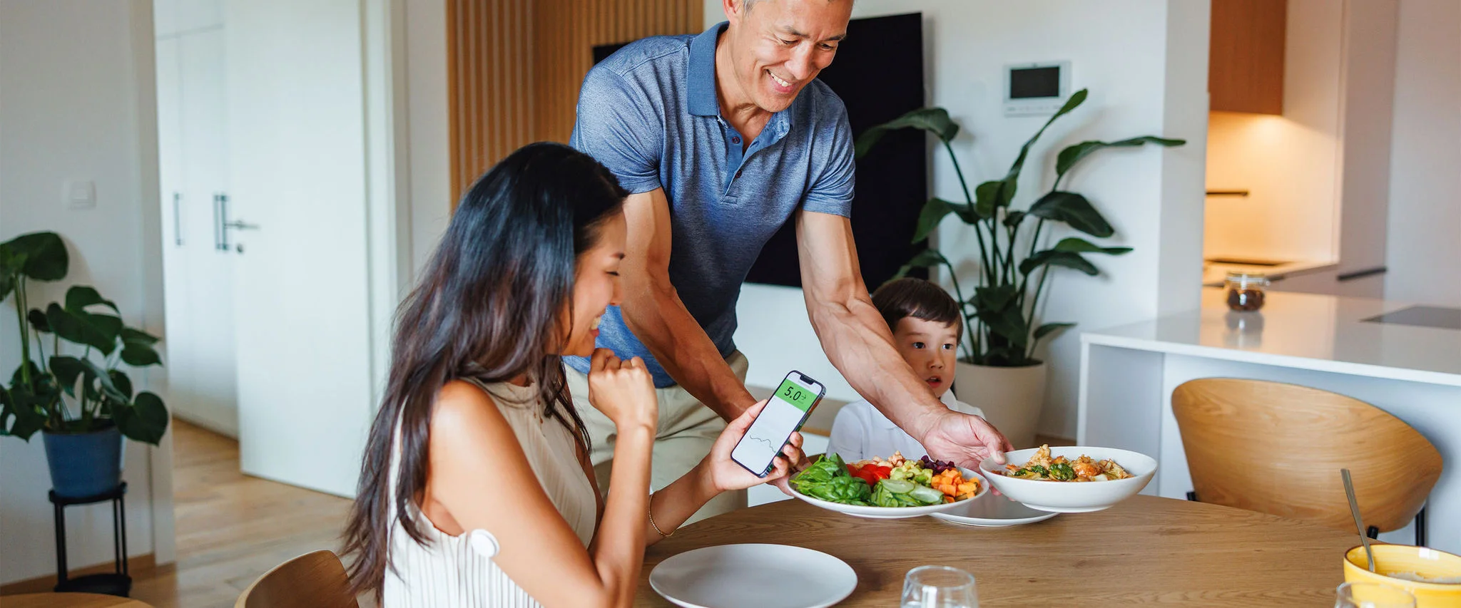 A man serving dinner at home with family