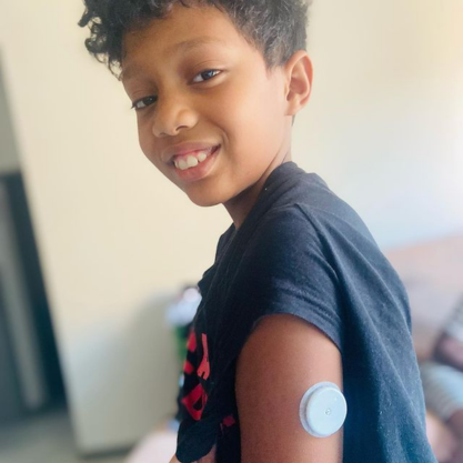 Young boy wearing FreeStyle Libre sensor on his left arm