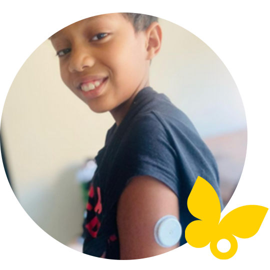 Lady in sun dress wearing a hat and FreeStyle Libre sensor