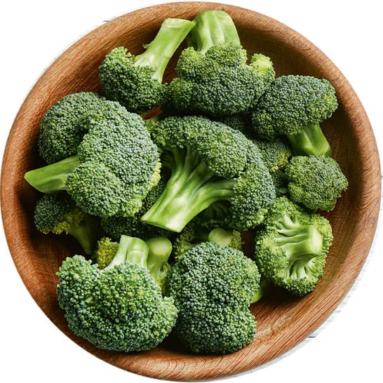 Fresh broccoli florets piled in a wooden bowl.