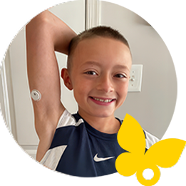 Kid smiling while wearing a FreeStyle Libre 3 Plus sensor