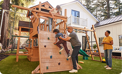 Family bonding together at their yard playground