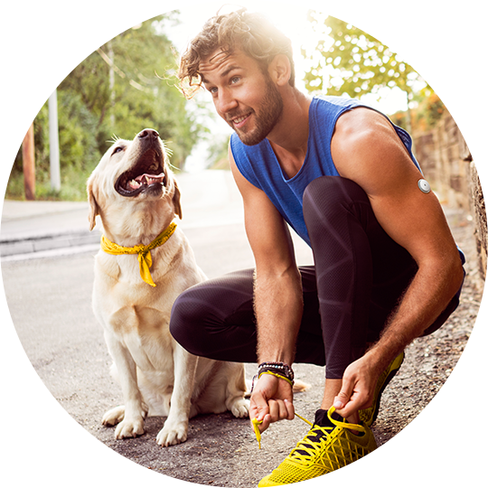 A woman wearing a FreeStyle Libre sensor while looking at her glucose levels on her FreeStyle Libre reader.