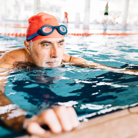 A man swimming in the pool.