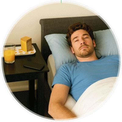 Man resting in bed while using the FreeStyle Libre 3 Plus sensor.