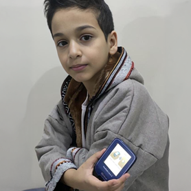 Boy holding sensor to his arm