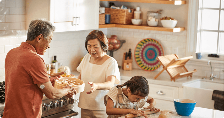Grandparents baking with granddaughter in the kitchen