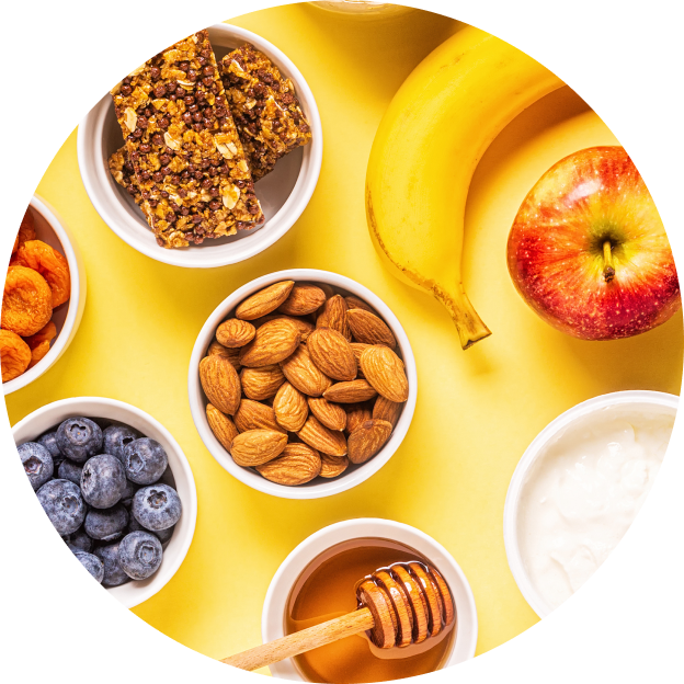 Portioned bowls of diabetes-friendly snacks like fresh fruit, nuts, and seeds on a table.