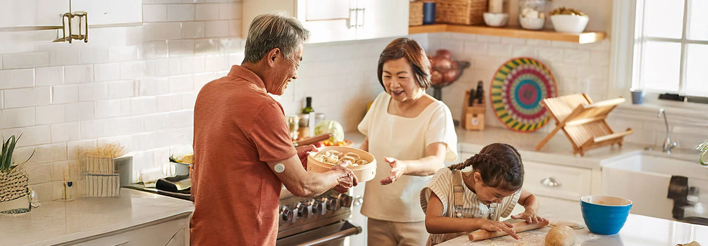Grandparents baking with granddaughter in the kitchen