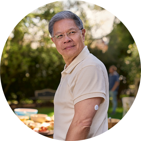 A man wearing a FreeStyle Libre sensor, having lunch on his porch.