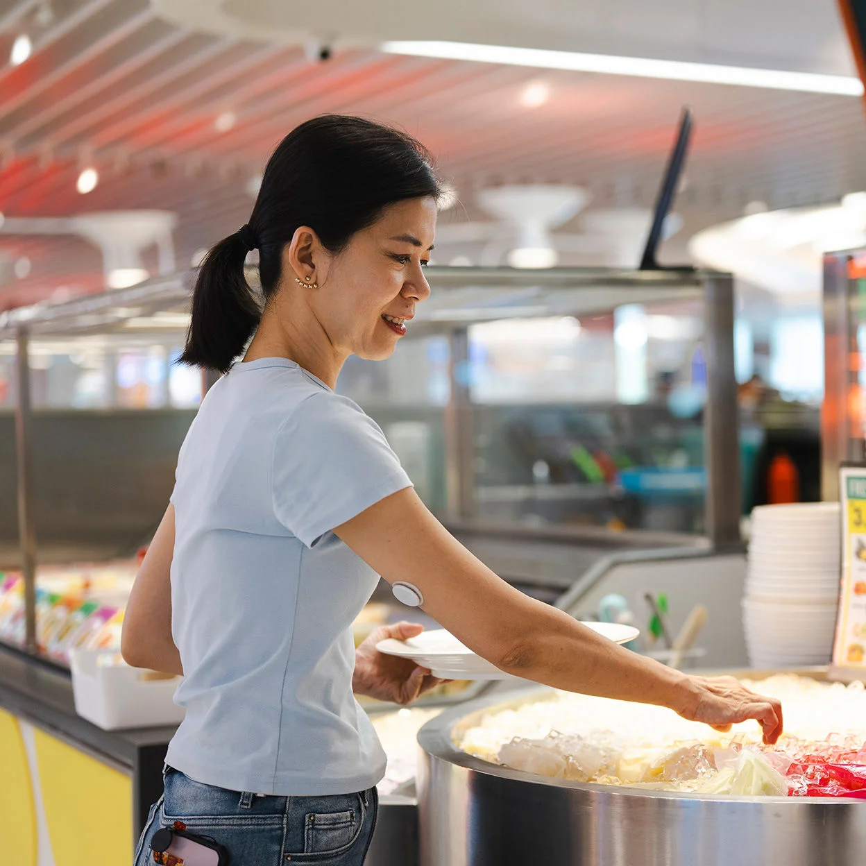 woman getting food at food counter
