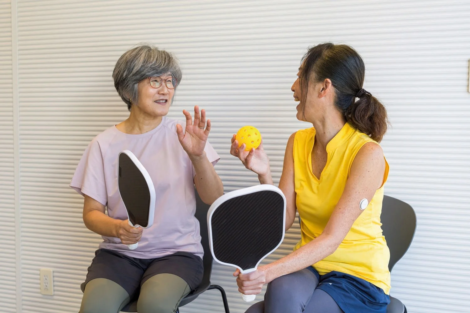 Two women playing pickle ball