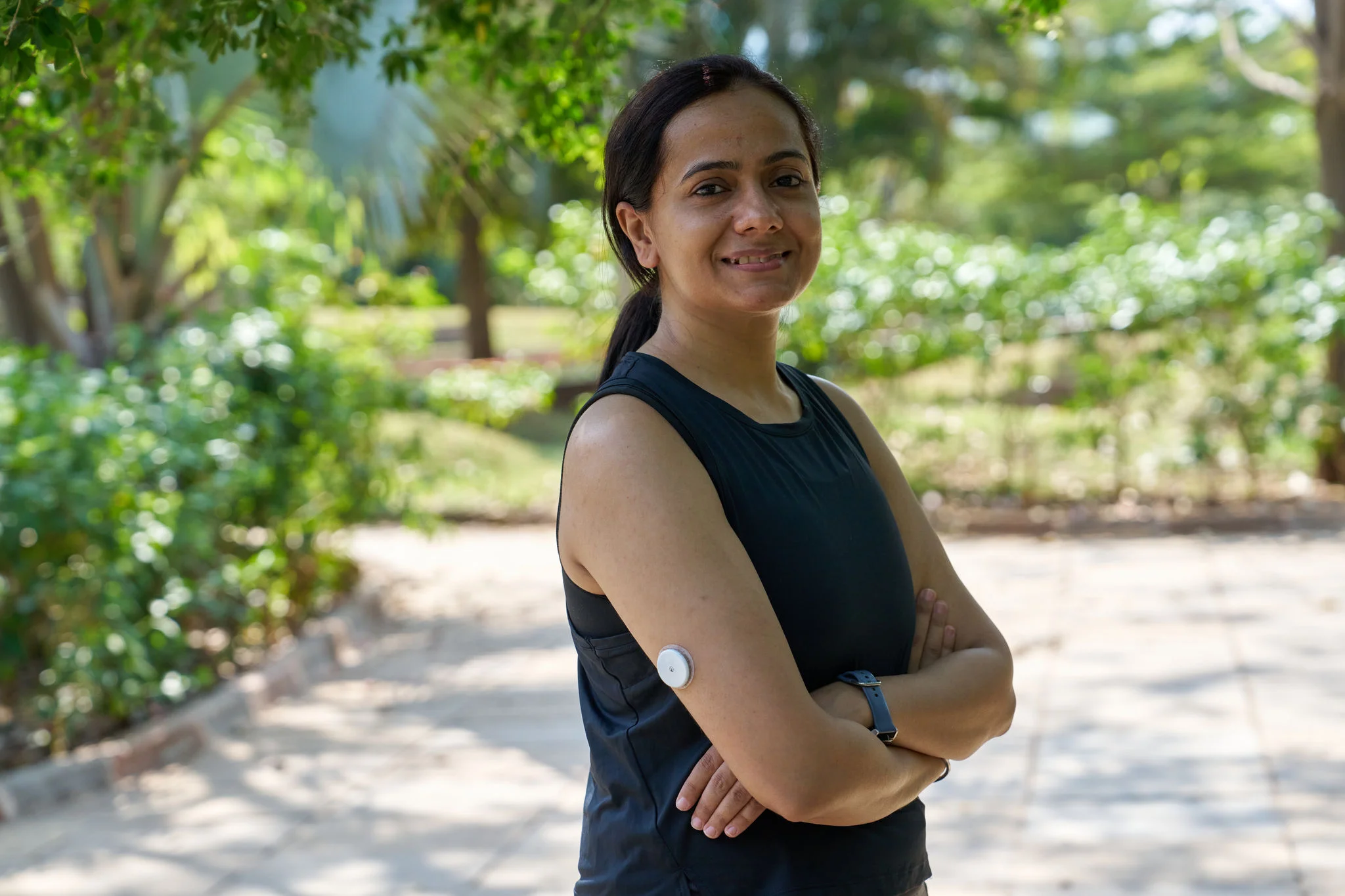 A woman wearing a sensor while standing outdoors