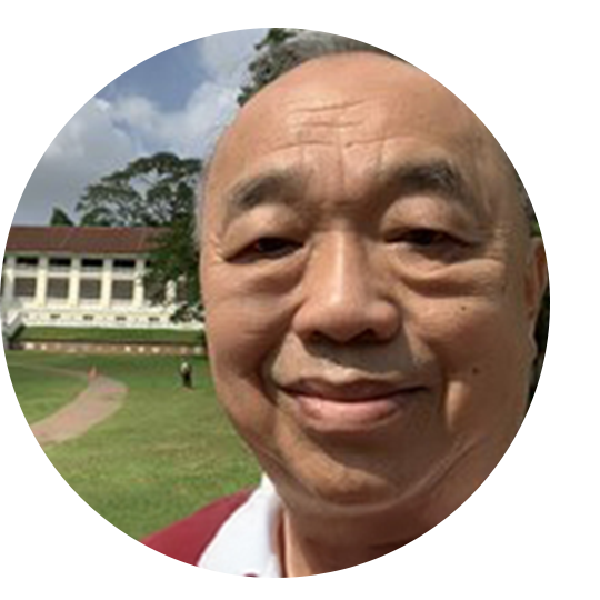 A woman wearing a sensor and holding her child in front of a fountain.