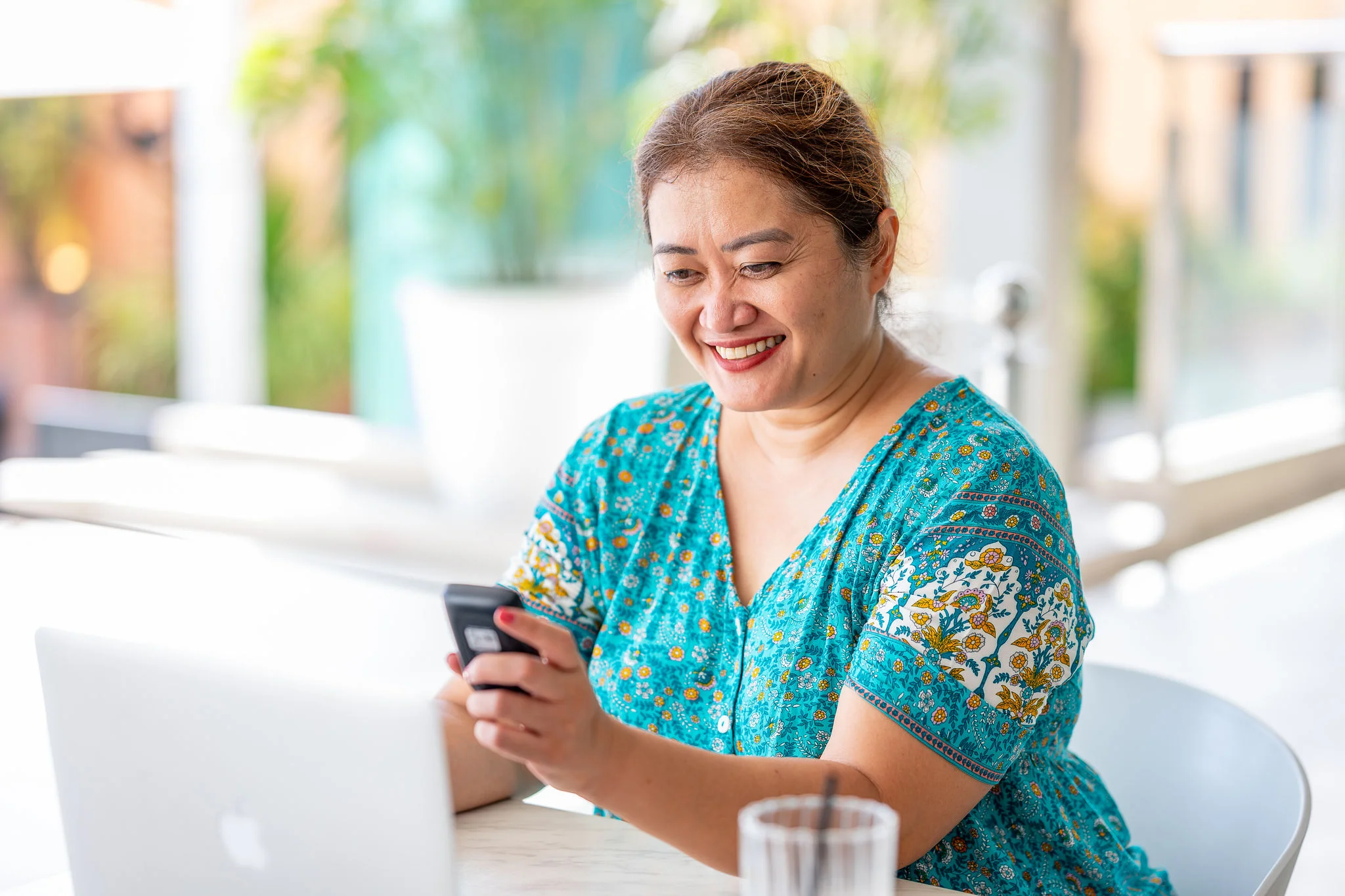 A woman smiling watching the reader