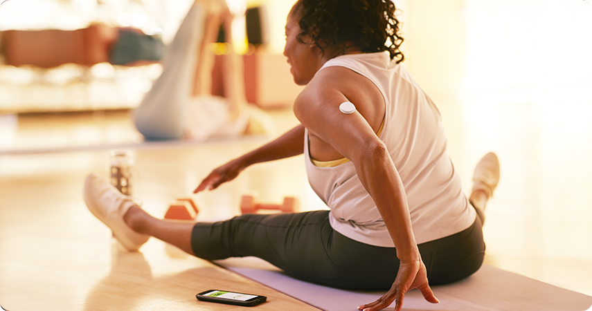 Woman doing stretch exercises on a mat