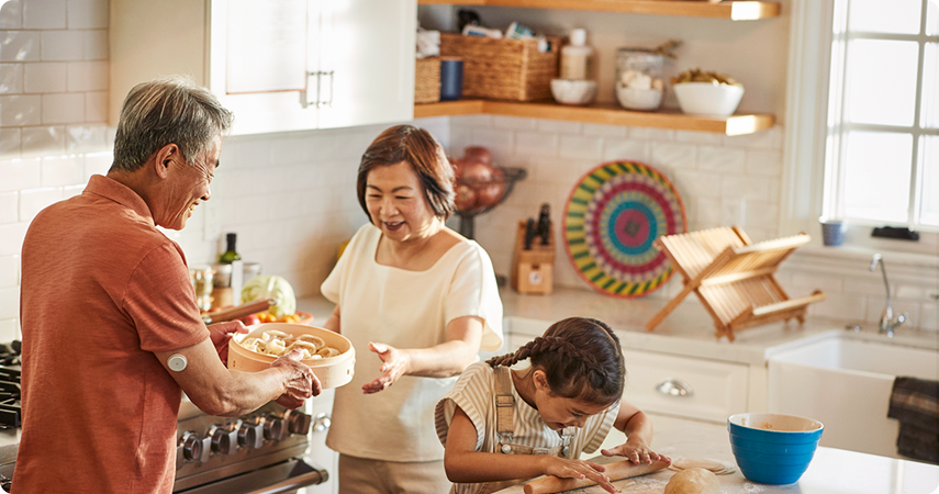 Grandparents baking with granddaughter in the kitchen