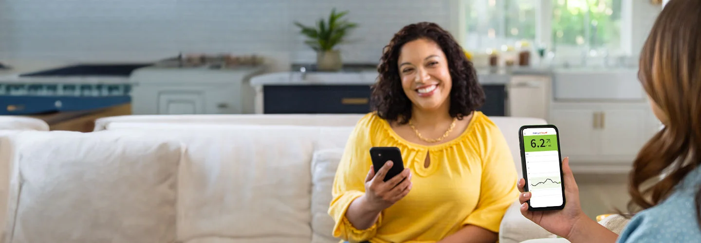 Girl looking at phone screen with glucose values