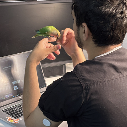 Man wearing sensor holding a bird