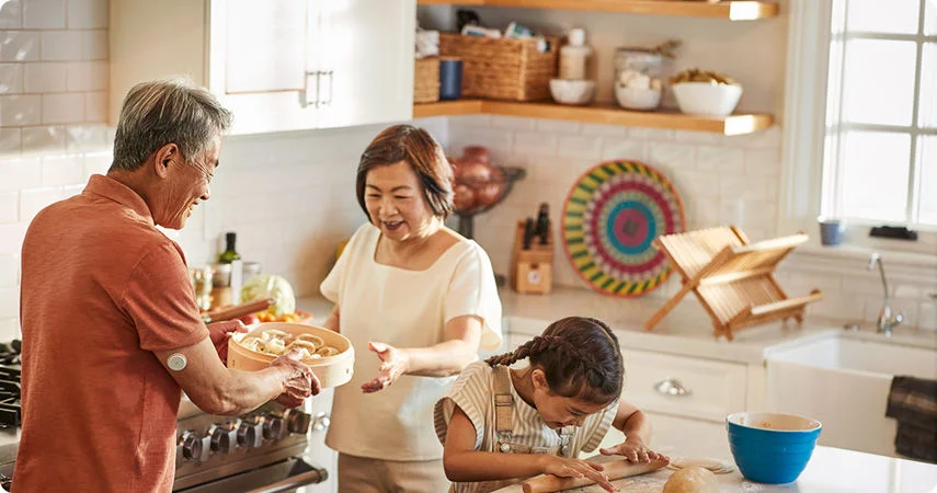 Grandparents baking with granddaughter in the kitchen