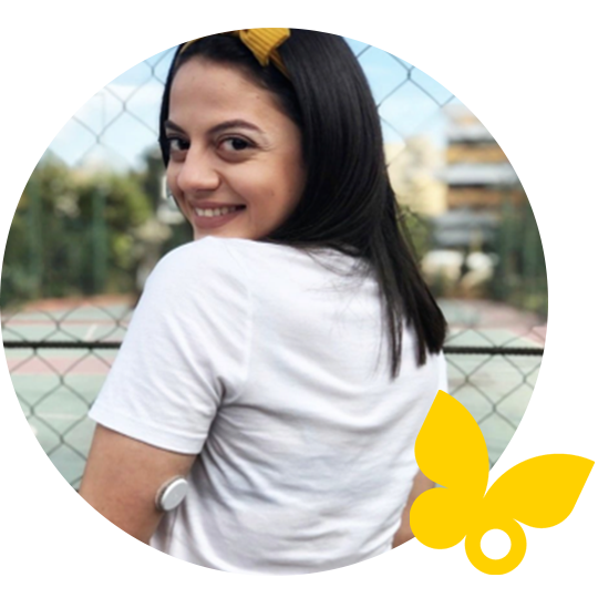 Young woman wearing sensor on arm, looking over her shoulder