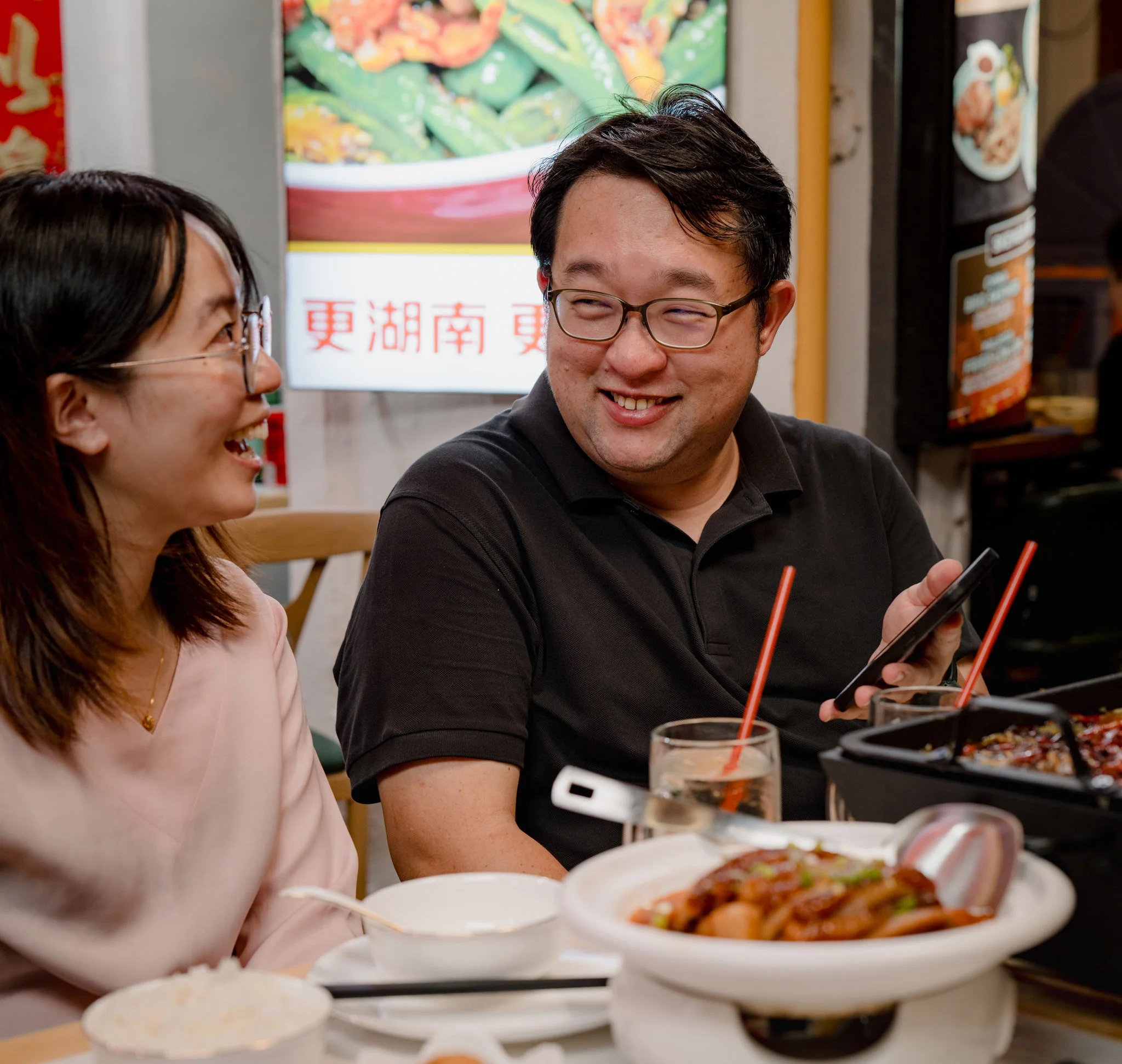 A man with tatoos wearing a sensor while eating.