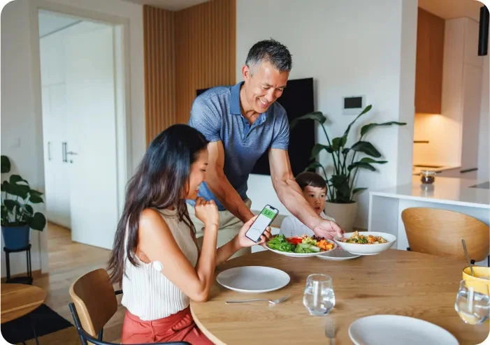 A man serving dinner at home with family