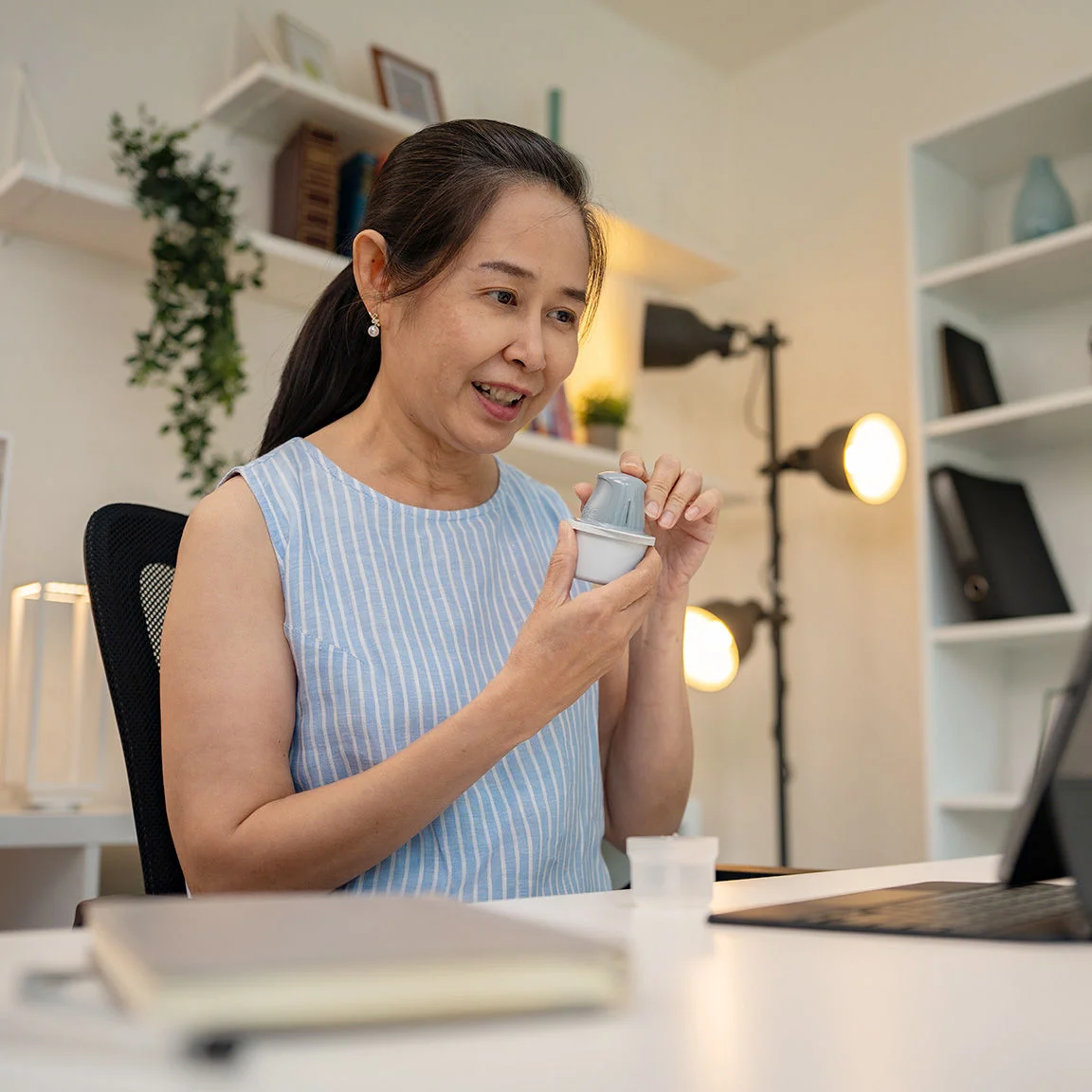 Woman applying a sensor via telemedicine