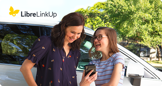 An image of Mom and teen looking at the smartphone screen.