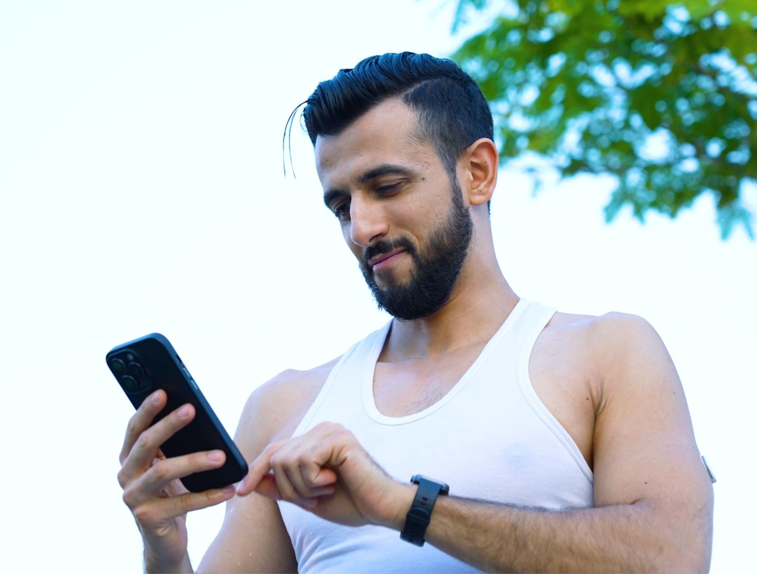 A woman wearing a sensor while standing in front of a prop plane.