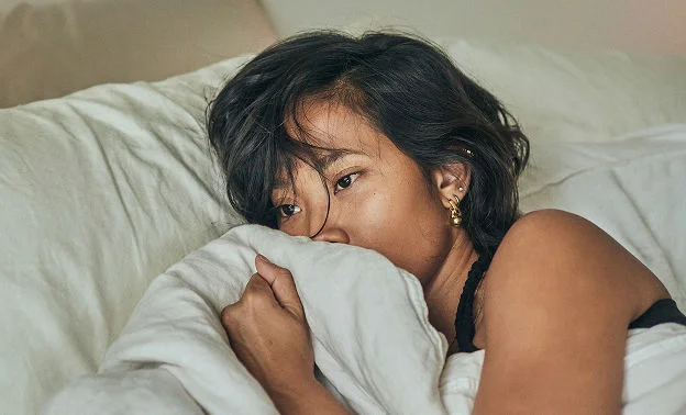 Person suffering symptoms of DKA laying in bed.