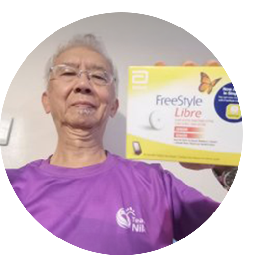 A woman wearing a sensor and holding her child in front of a fountain.