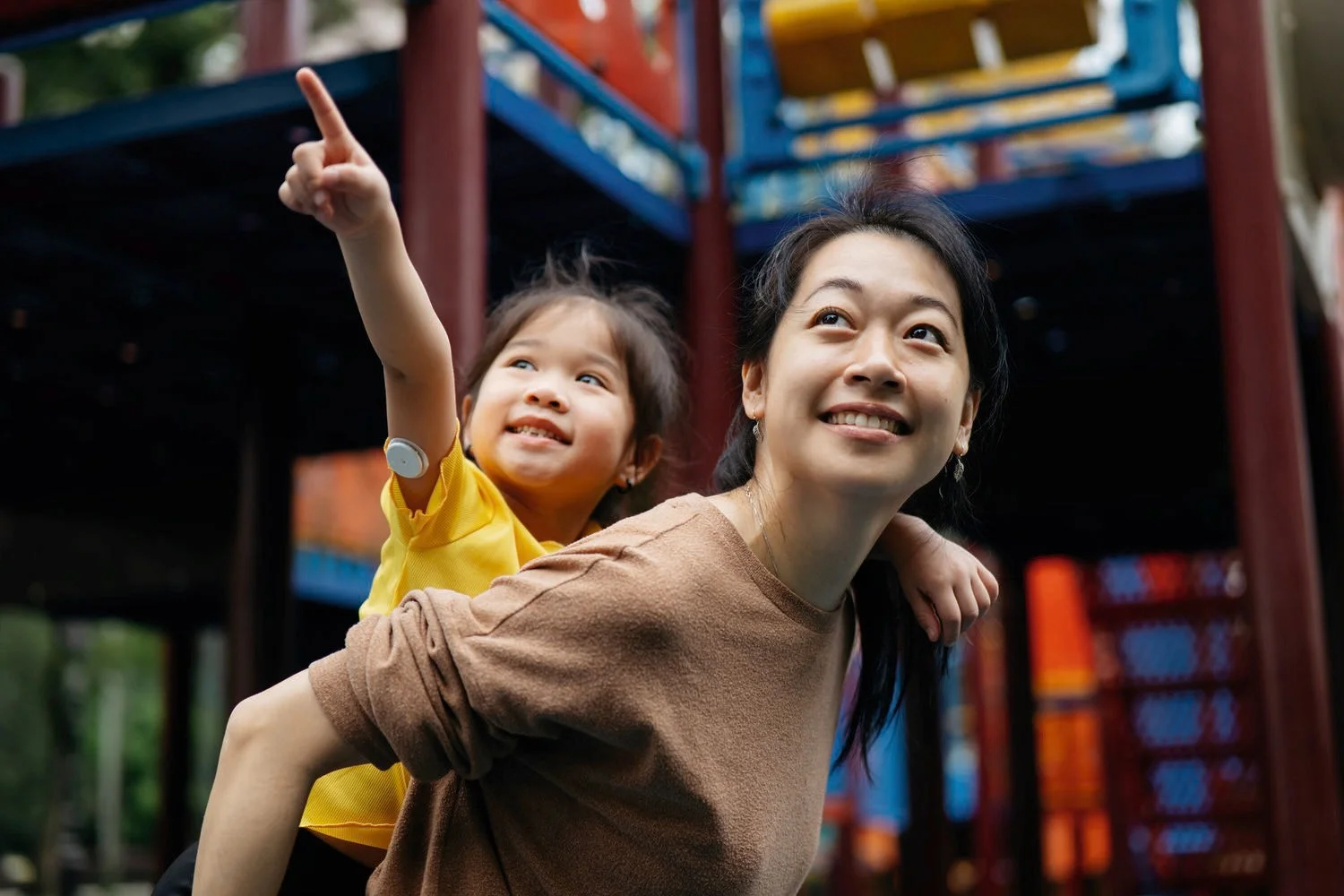A woman giving a girl with FSL 2 sensor a piggy back ride