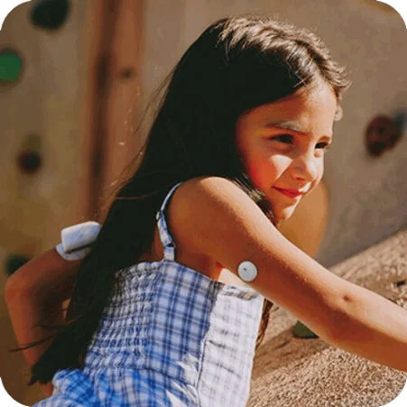 Child in the playground wearing a FreeStyle Libre 3 Plus sensor