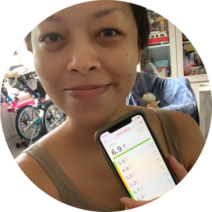 A woman wearing a sensor showing app reading