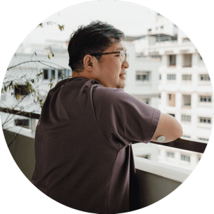 A manwearing sensor looking out from balcony