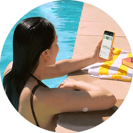 Woman by the pool wearing a FreeStyle Libre 3 Plus sensor