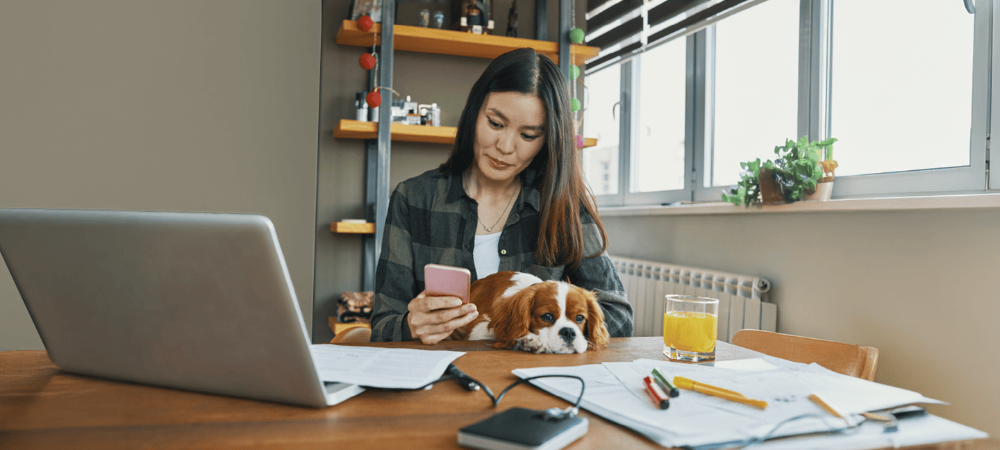 Woman with dog checking phone