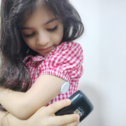 Young girl taking glucose reading