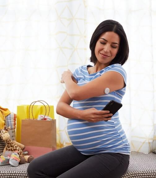 Mujer embarazada monitoreando sus niveles de glucosa.