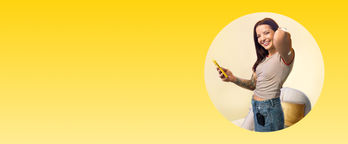 Woman standing by a chair while wearing a FreeStyle Libre 3 Plus sensor