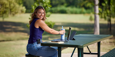 Smiling man wearing a FreeStyle Libre 2 Plus sensor and Omnipod® 5 insulin pump checks his blood glucose