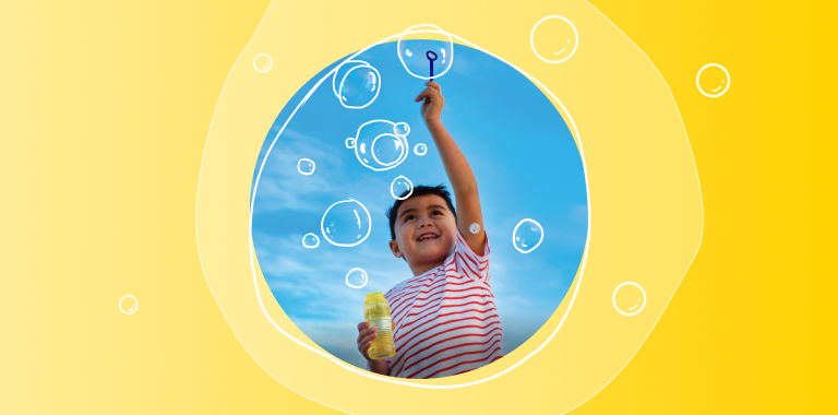 Child playing with bubbles while wearing a FreeStyle Libre 3 Plus sensor