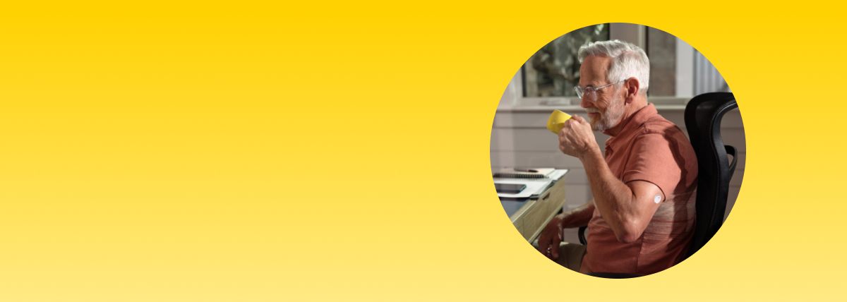 Man drinking coffee while wearing a FreeStyle Libre systems sensor