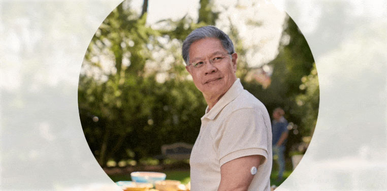 Man standing outdoors wearing a FreeStyle Libre 2 sensor