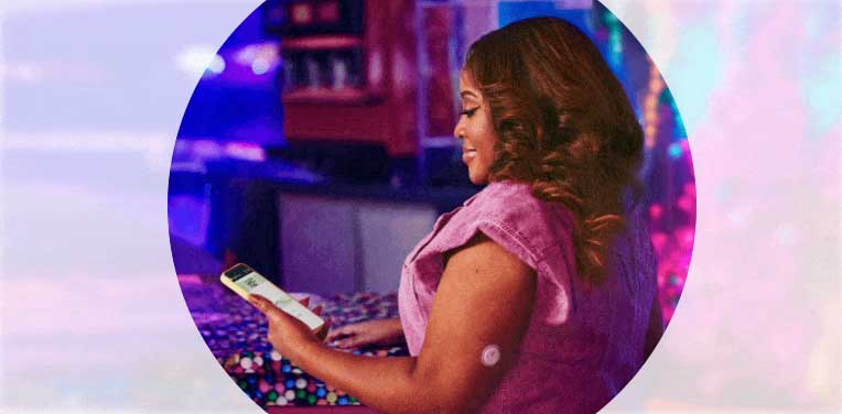 Sherri Shepherd wearing a FreeStyle Libre 3 Plus sensor and checking her blood glucose on a smartphone